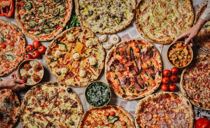 A table of Johnny Gio's pizzas ready to share